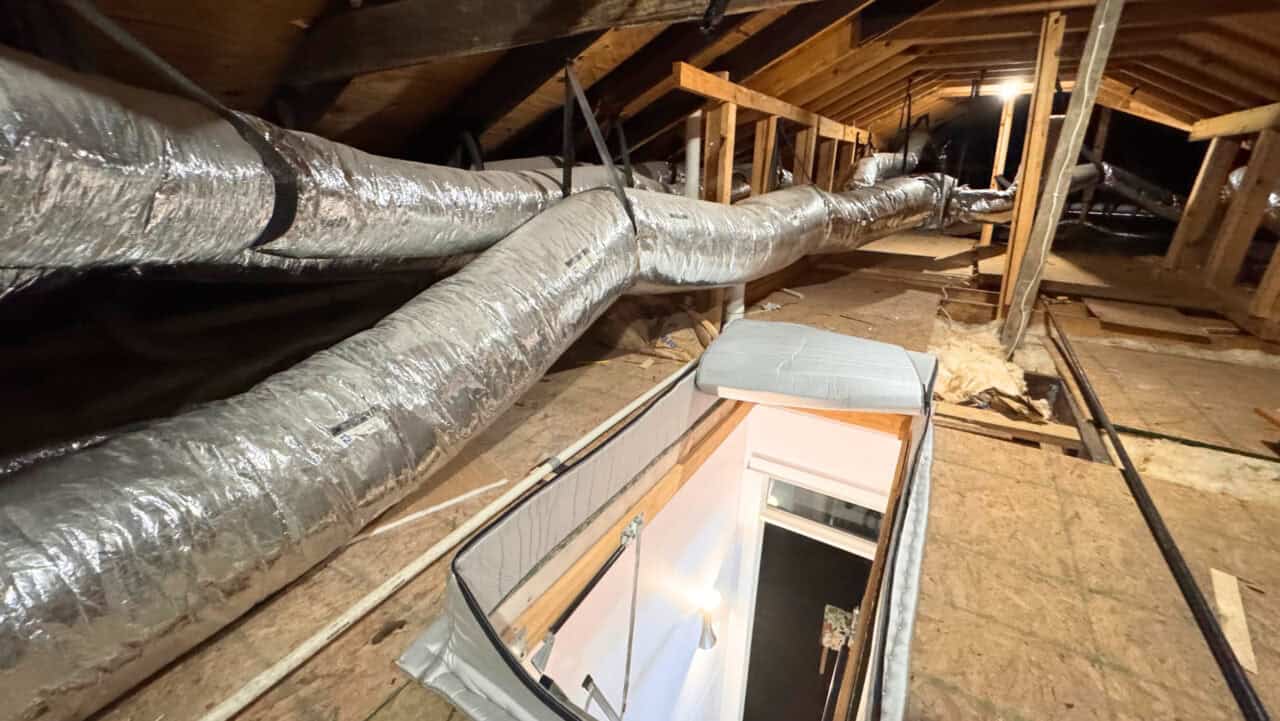 Thirty-two-foot flexible flexible HVAC ductwork run with only three tight straps restricting airflow and causing condensation 