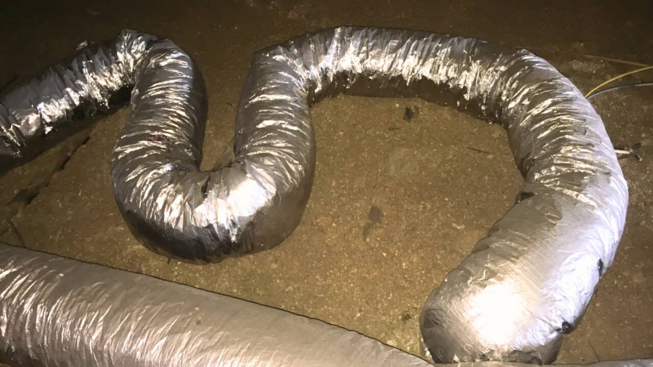 Image of improperly installed flexible HVAC ductwork. The flexible ductwork is too long and has multiple "S-Turns" that drastically reduce efficiency.